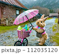 雨の中、傘を持ってベビーカーを押しているうさぎ 112035120
