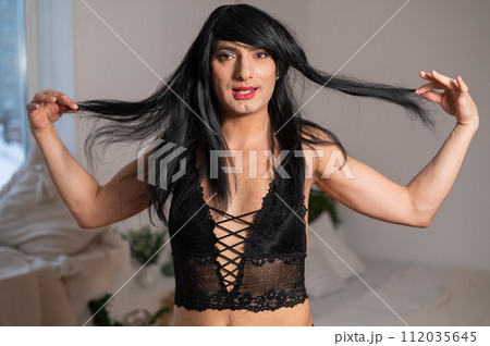 Gay man in wig and black lace lingerie.  112035645
