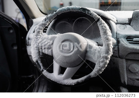 Car interior in a layer of cleaning foam. Car interior in a layer of cleaning foam. 112036273