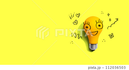 Yellow light bulb with happy face 112036503