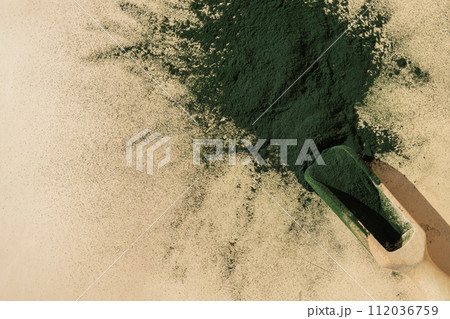 Organic blue-green algae spirulina powder food in wooden spoon. Copy space for your text Health benefits of spirulina chlorella. Vitamins and minerals to diet. Detox dietary supplement Seaweed 112036759