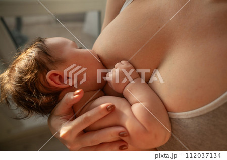 Caucasian woman breastfeeds her four-month-old son. Caucasian woman breastfeeds her four-month-old son. 112037134