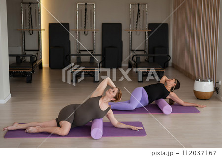 Two pregnant women doing yoga. Preparing for the birth of a child. Two pregnant women doing yoga. Preparing for the birth of a child. 112037167