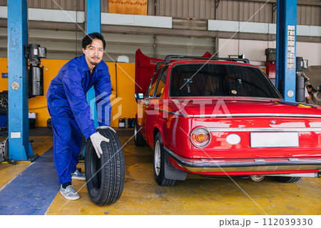 Asian Japanese male mechanic worker portrait in auto service workshop car tyre maintenance center replace fix auto part Asian Japanese male mechanic worker portrait in auto service workshop car tyre maintenance center replace fix auto part 112039330