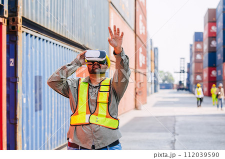 Worker Using VR Vision Pro Technology Equipment Headset Device Work at Container Yard Construction site Innovation in Logistics Industry Worker Using VR Vision Pro Technology Equipment Headset Device Work at Container Yard Construction site Innovation in Logistics Industry 112039590