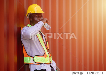 African black worker male brake relax drinking water for refreshing from hard working in hot day summer season African black worker male brake relax drinking water for refreshing from hard working in hot day summer season 112039591