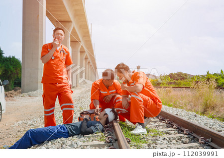 paramedic,medical,emergency,doctor,team,working,in,action,help,first,aid,save,people,life,at,accident,site,outdoors 112039991