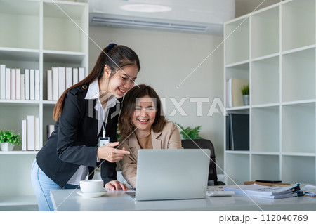 Two businesswoman discussing partner discussing project on laptop in office. Two colleague of professional business people working together at workspace Two businesswoman discussing partner discussing project on laptop in office. Two colleague of professional business people working together at workspace 112040769