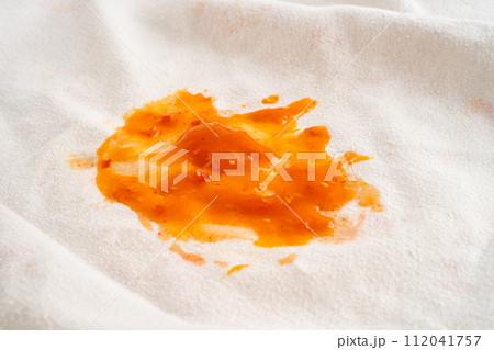 Dirty tomato sauce stain or ketchup on cloth to wash with washing powder, cleaning housework. Dirty tomato sauce stain or ketchup on cloth to wash with washing powder, cleaning housework. 112041757