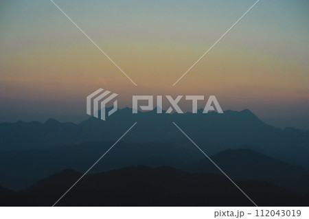 landscape and travel concept with sunset and twilight sky with layer of mountain 112043019