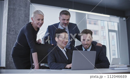 Excited group of company employees finishing work, successful team smiling 112046689