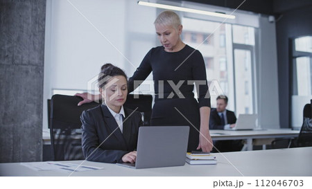 Bossy business lady annoyed with employee's work results, criticizing upset colleague Bossy business lady annoyed with employee's work results, criticizing upset colleague 112046703