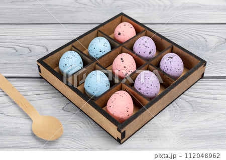 Colorful Easter eggs in a box on the wooden background 112048962