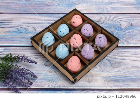 Colorful Easter eggs in a box on the wooden background 112048966