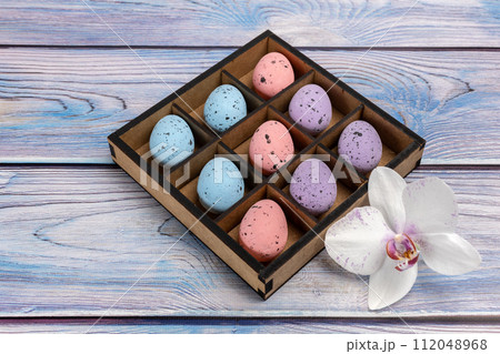 Colorful Easter eggs in a box on the wooden background 112048968