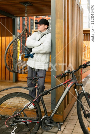 Bike rental concept. A man took a break while cycling Bike rental concept. A man took a break while cycling 112049476
