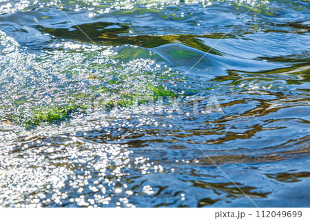 flow of water and spray from a stone flow of water and spray from a stone 112049699