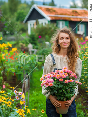 Young woman gardening in greenhouse.She selecting flowers. Young woman gardening in greenhouse.She selecting flowers. 112049888