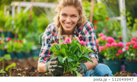 Young woman gardening in greenhouse.She selecting flowers. Young woman gardening in greenhouse.She selecting flowers. 112049947