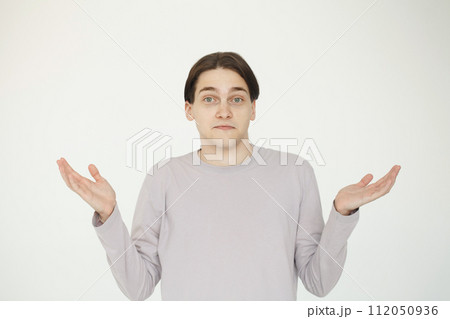 Confused guy showing two empty open hand isolated on white background 112050936