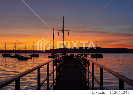 Bodensee Lake Sunrise Panorama. Morning Sunlight Over Tranquil Waters. Bodensee Lake Sunrise Panorama. Morning Sunlight Over Tranquil Waters. 112051245