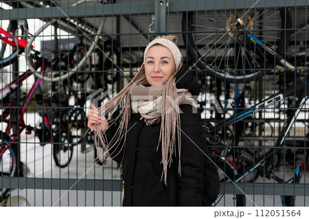 Cute young woman actively spending time outdoors in winter Cute young woman actively spending time outdoors in winter 112051564