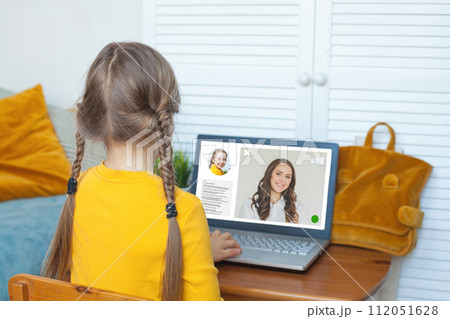 Online learning and education technology concept. Child girl studying online at home Online learning and education technology concept. Child girl studying online at home 112051628
