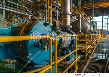 Industrial machinery with an array of steel pipes, cables, and valves in a manufacturing setting 112051820