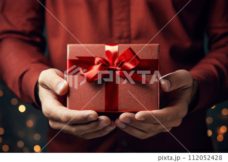 man in shirt holding gift cardboard box with red bow 112052428