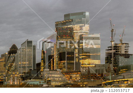The illuminated of skyscraper in the business district of London just after sunset. 112053717