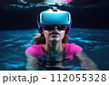 Young woman wearing virtual reality glasses under the water. Concept of dive into the Metaverse. 112055328