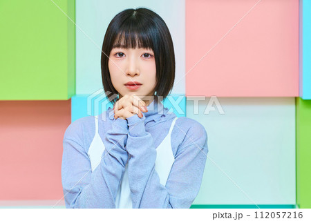 お祈りのポーズをする若い女性とカラフルな背景 お祈りのポーズをする若い女性とカラフルな背景 112057216