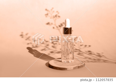 Natural oil cosmetics. Dropper glass Bottle Mock-Up. Oily cosmetic pipette. Face and body treatment. Spa concept. Mineral organic liquid. Front view. Beauty products. Blank packaging on wooden table Natural oil cosmetics. Dropper glass Bottle Mock-Up. Oily cosmetic pipette. Face and body treatment. Spa concept. Mineral organic liquid. Front view. Beauty products. Blank packaging on wooden table 112057835