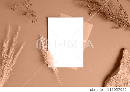 Blank greeting card, invitation mockup. Dry grass, pampas plant on beige table background. Flat lay, top view. Copyspace. Paper cards, mock up. Modern Minimal business brand template. Soft shadow. A6 Blank greeting card, invitation mockup. Dry grass, pampas plant on beige table background. Flat lay, top view. Copyspace. Paper cards, mock up. Modern Minimal business brand template. Soft shadow. A6 112057922