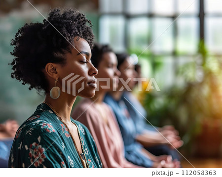 Group of diverse woman practicing spiritual mindfulness, yoga and meditation in a relaxing setting Group of diverse woman practicing spiritual mindfulness, yoga and meditation in a relaxing setting 112058363