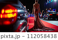 Celebrity woman in long fashionable luxury gown walking on a red carpet to celebrity gala event 112058438