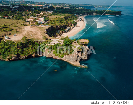 Aerial view of tropical beach with scenic rock and ocean in Bali 112058845