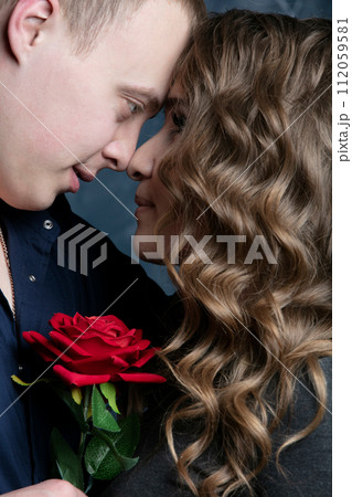 Profile of a beautiful girl and guy with a red rose Profile of a beautiful girl and guy with a red rose 112059581