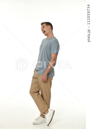 surprised guy looking at camera on white studio background 112059734