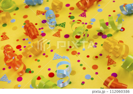 Festive yellow background with serpentine ribbons, confetti, party concept, children's birthday. High quality 4k footage Festive yellow background with serpentine ribbons, confetti, party concept, children's birthday. High quality 4k footage 112060386