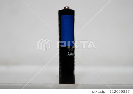 AAA-Size Battery Standing Upright on a White Surface AAA-Size Battery Standing Upright on a White Surface 112060837