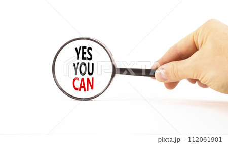 Motivational Yes you can symbol. Concept words Yes you can in beautiful magnifying glass. Beautiful white table background. Businessman hand. Business motivational and Yes you can concept. Copy space Motivational Yes you can symbol. Concept words Yes you can in beautiful magnifying glass. Beautiful white table background. Businessman hand. Business motivational and Yes you can concept. Copy space 112061901