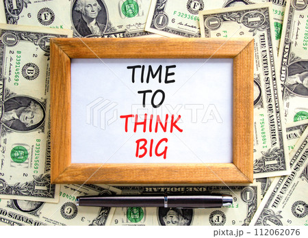 Time to think big symbol. Concept words Time to think big on beautiful wooden frame. Black pen. Beautiful dollar bills background. Dollar bills. Business and time to think big concept. Copy space. 112062076