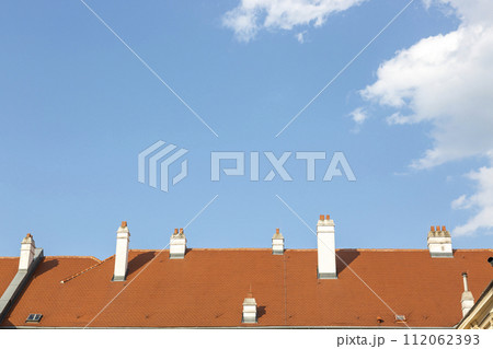 Chimneys on the roof of the house against the sky 112062393
