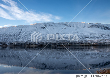 Reflection of a mountain in the fjord, Iceland Reflection of a mountain in the fjord, Iceland 112062463