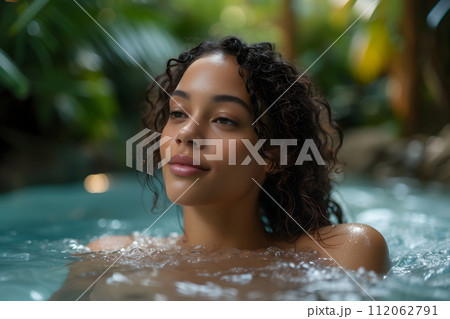 Serenity Oasis: Young Woman Basks in Outdoor Spa Pool Beauty Serenity Oasis: Young Woman Basks in Outdoor Spa Pool Beauty 112062791