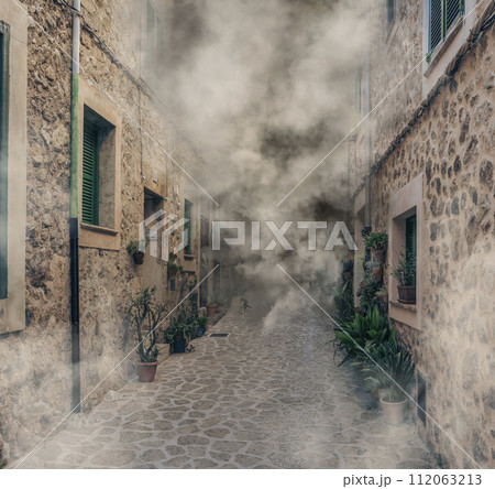 Mysterious Fog Enveloping a Traditional Cobblestone Alley in a Historic Village Mysterious Fog Enveloping a Traditional Cobblestone Alley in a Historic Village 112063213