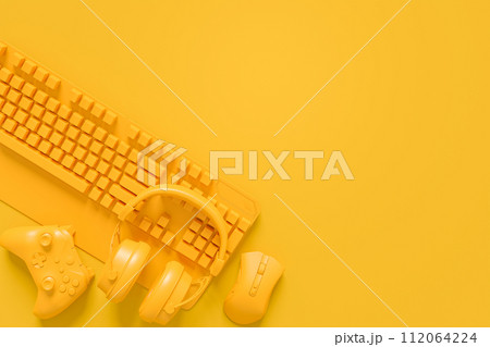 Modern home office setup featuring keyboard, gaming controllers and headphones Modern home office setup featuring keyboard, gaming controllers and headphones 112064224