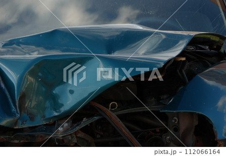 Close-up of a dark blue car physically damaged in a traffic accident. Close-up of a dark blue car physically damaged in a traffic accident. 112066164
