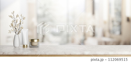 A luxury marble tabletop with a lotion tube, a facial cream, a flower vase in an elegant bathroom. A luxury marble tabletop with a lotion tube, a facial cream, a flower vase in an elegant bathroom. 112069515